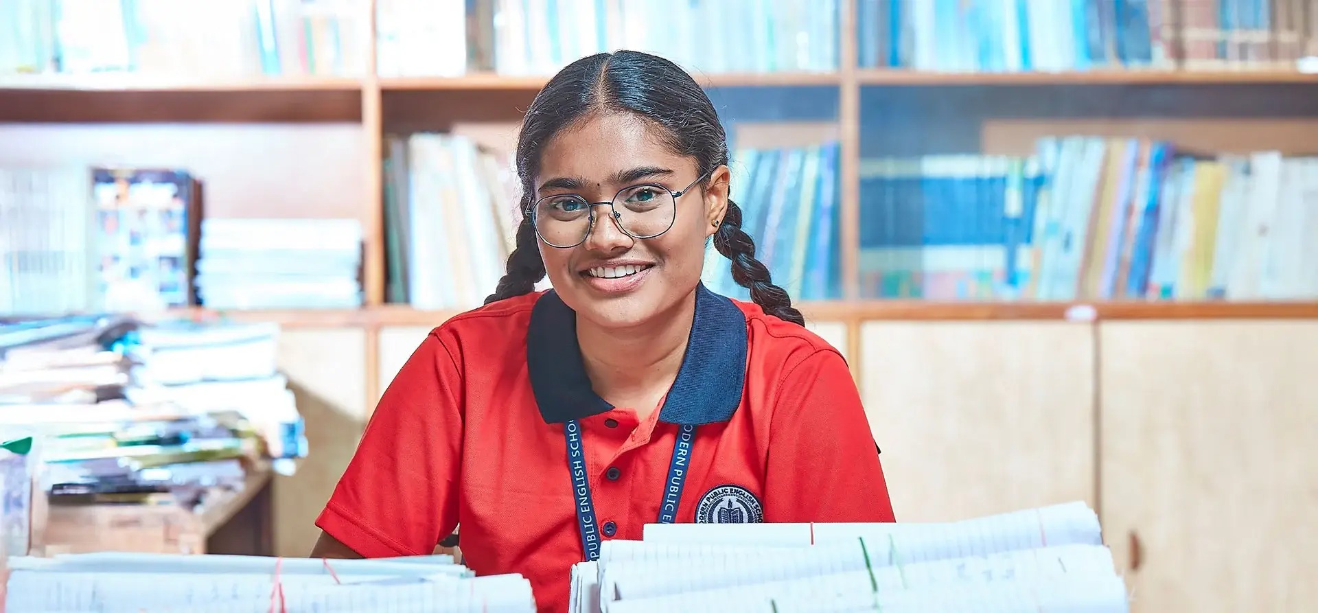 Teacher reading story to group of young children in cozy reading corner